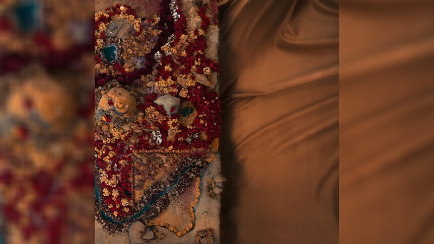 artwork for Winterbourne's 2023 album Act of Disappearing - photo of silk tarp and a miniature floral arrangement