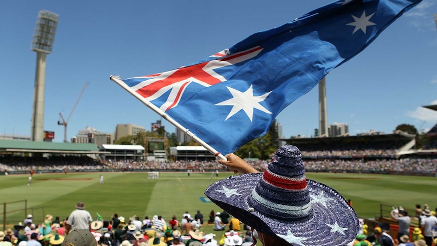 Cricket generic of fan in crowd waving Aussie flag