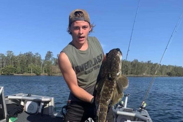 Young man hold fish