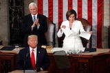 Donald Trump stands at the microphone while Mike Pence stands behind clapping, and Nancy Pelosi rips up papers.