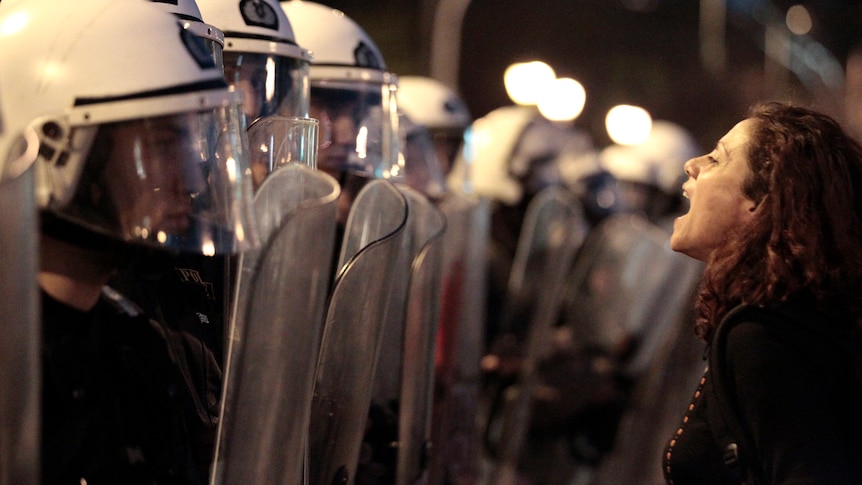 Protester shouts at policemen in Athens