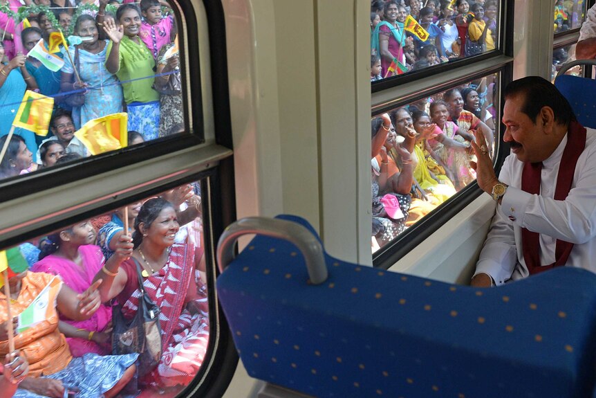 Sri Lankan President Mahinda Rajapake waves to crowds