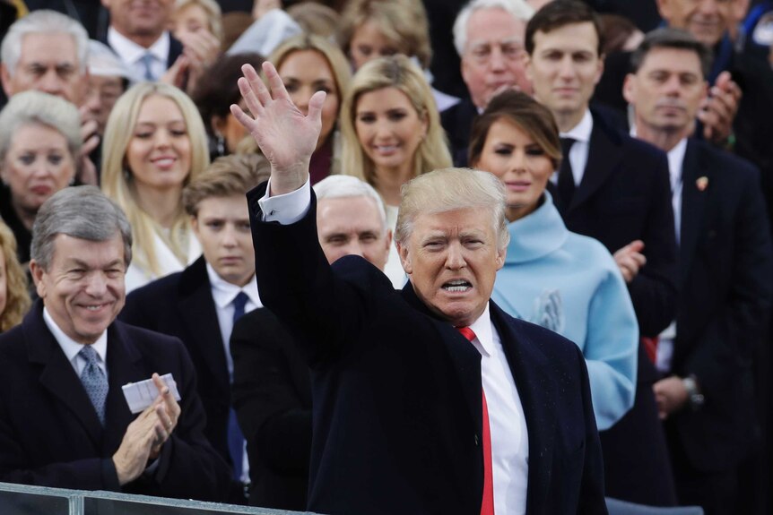President Donald Trump waves after delivering his inaugural address