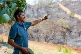 Jeff Pershouse points to the damage caused by bushfires at The Caves, north of Rockhampton, on November 30, 2018.
