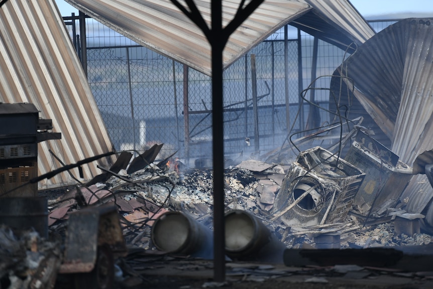 Fire damaged items sitting on a pile of rubble, with twisted metal