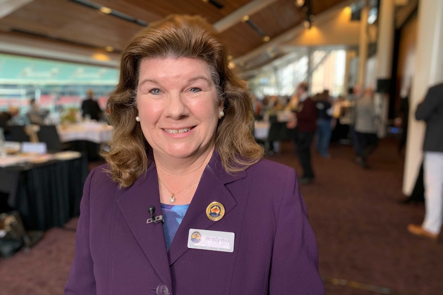 Wendy Hick smiling while wearing a purple blazer