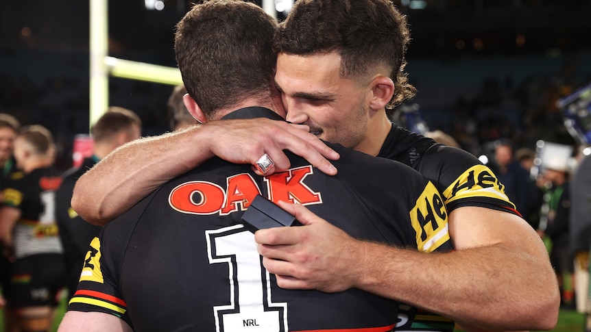 Two men embrace after a grand final