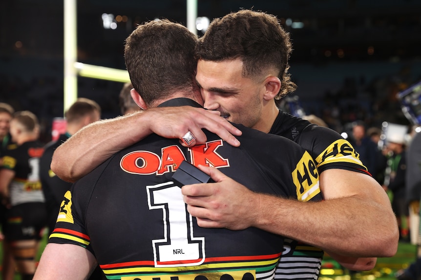 Two men embrace after a grand final