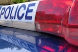 Tasmania Police sign on top of a car.