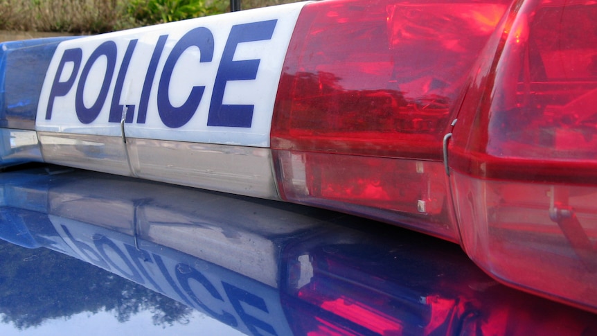 Tasmania Police sign on top of a car.