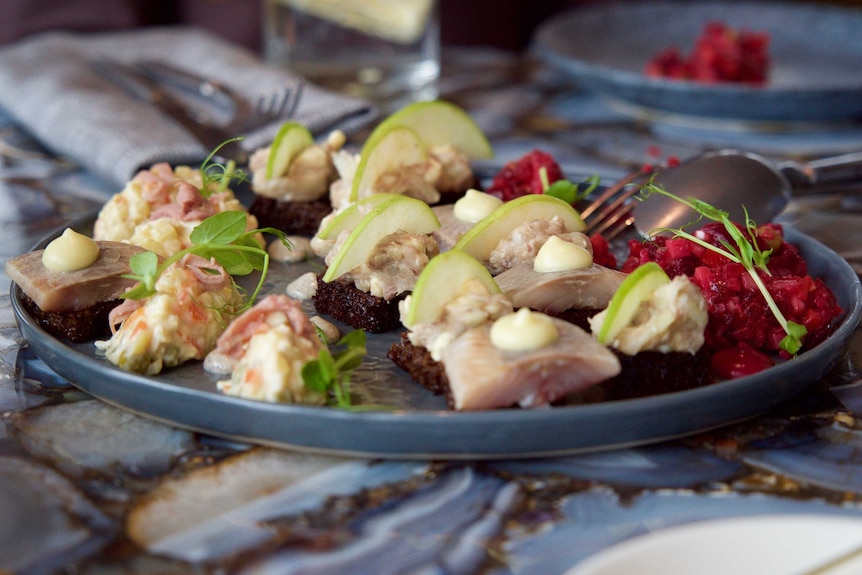 Pickled herring served with served with black bread and forshmak (minced fish) with black bread