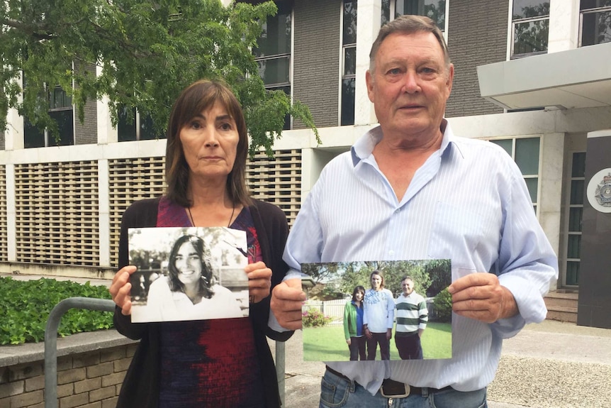The parents of murdered Canberra man Eden Waugh, Elaine and David, hold photographs of their son.