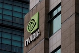 A green logo that reads "Nvidia" on the side of a brown building.