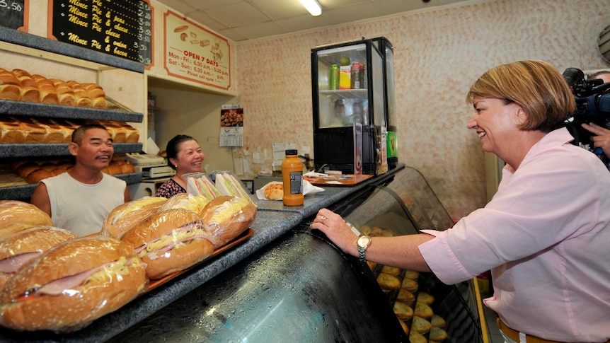 Anna Bligh chats to owners of a bakery at a Banyo shopping centre.