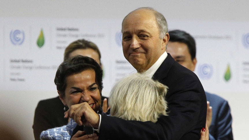 Foreign affairs minister and president-designate of COP21 Laurent Fabius celebrates after Paris climate deal