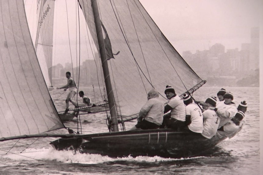 Black and white historical shot of sailers on sailing boat in sydney