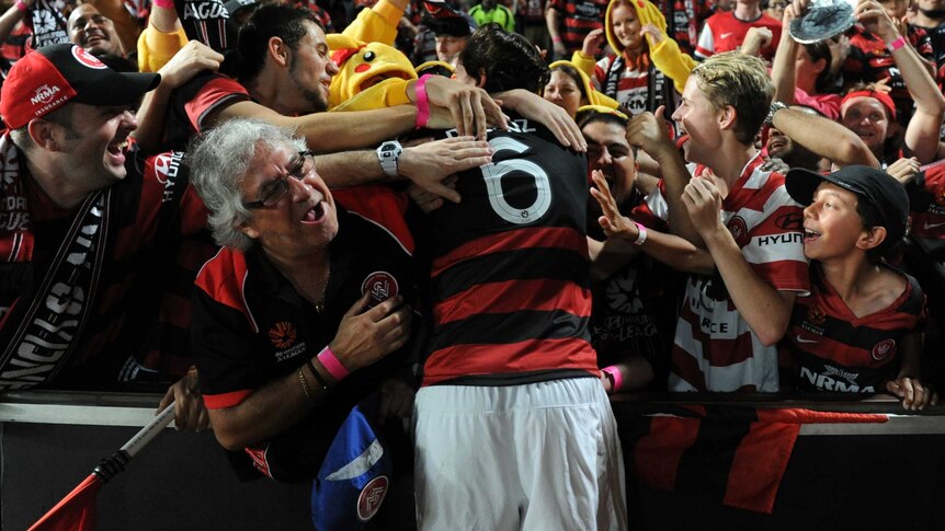 Joyous moments ... Wanderers fans embrace Jerome Polenz after the final whistle.