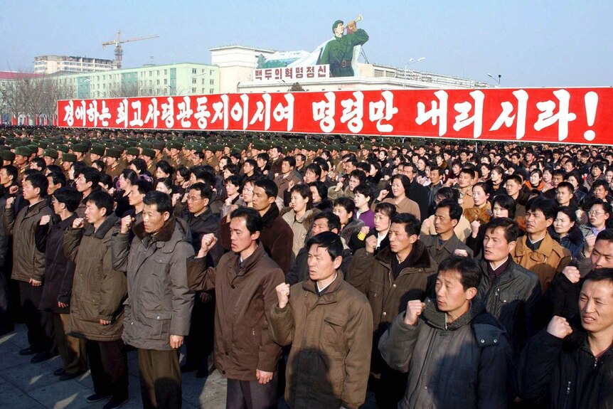 North Koreans attend a rally