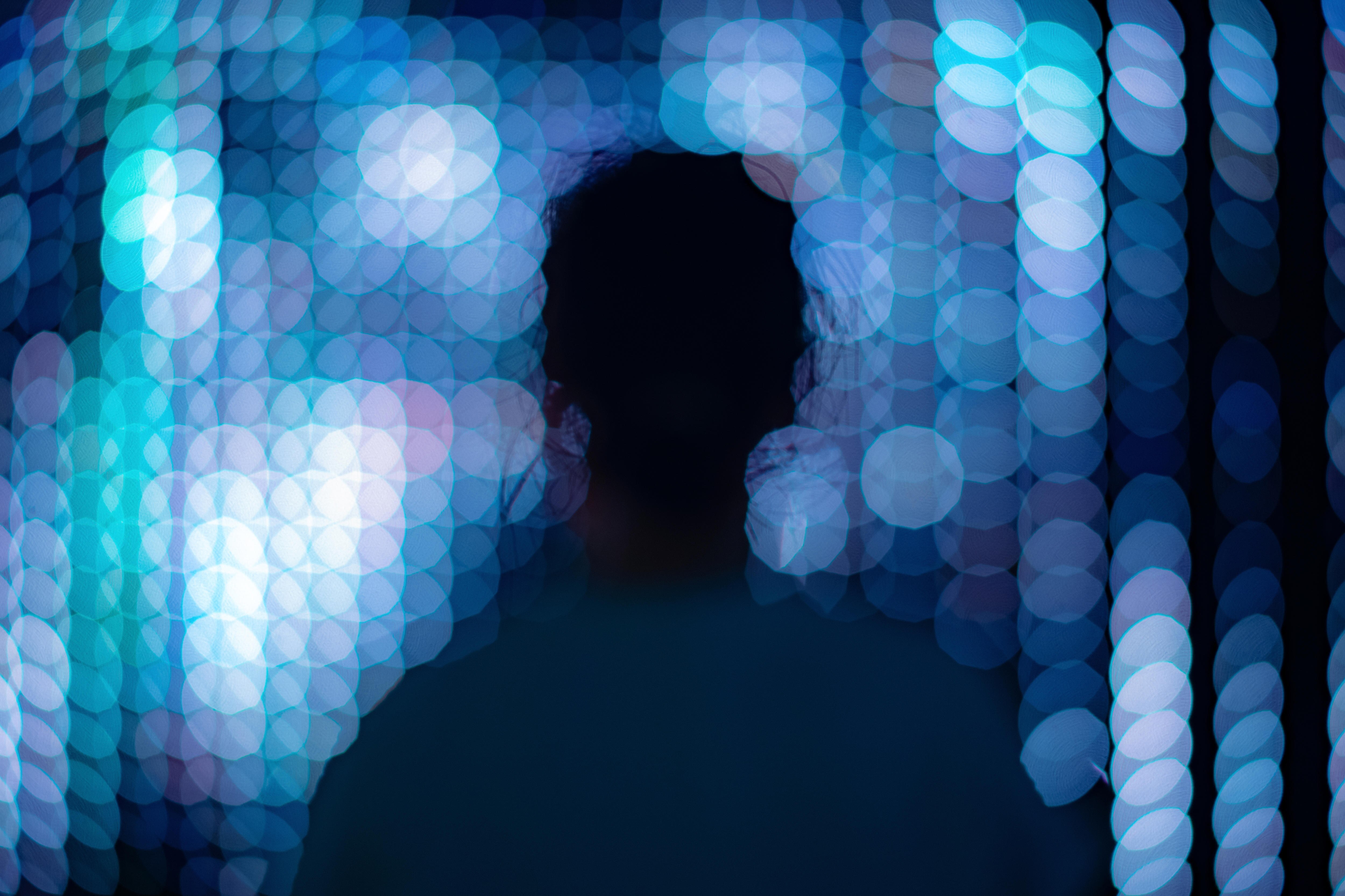 Figure alone against an unfocussed blue LED background