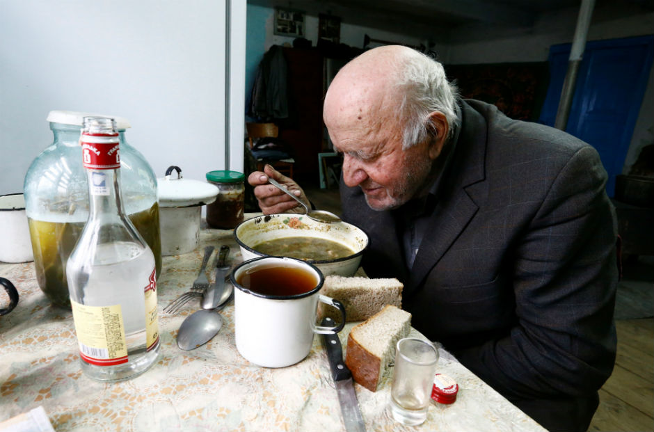 Ivan Shamyanok eats a bowl of soup with plain bread for lunch.