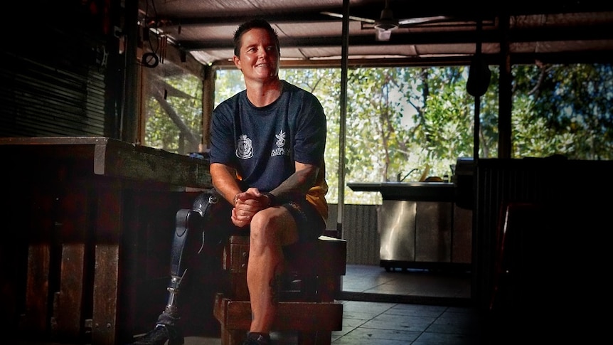 Corporal Sonya Newman pictured in a dimly lit room with her prosthetic right leg clearly visible