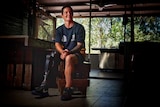 Corporal Sonya Newman pictured in a dimly lit room with her prosthetic right leg clearly visible