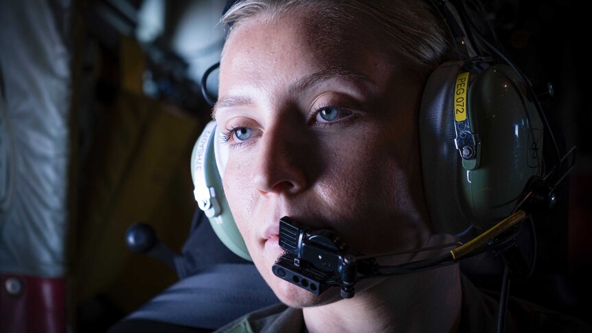 Corporal Jasmine Elliot looking out the window of a C-130 Hercules, set for the Solomon Islands.