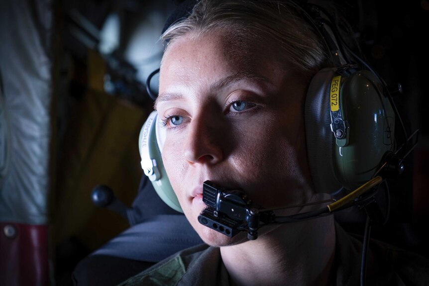 Corporal Jasmine Elliot looking out the window of a C-130 Hercules, set for the Solomon Islands.