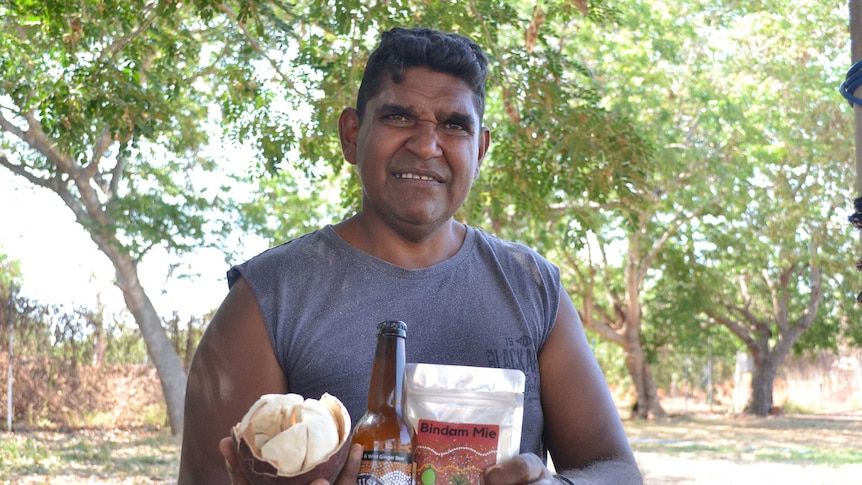 Broome man Robert Dann holding a range of the products he makes using boab nuts