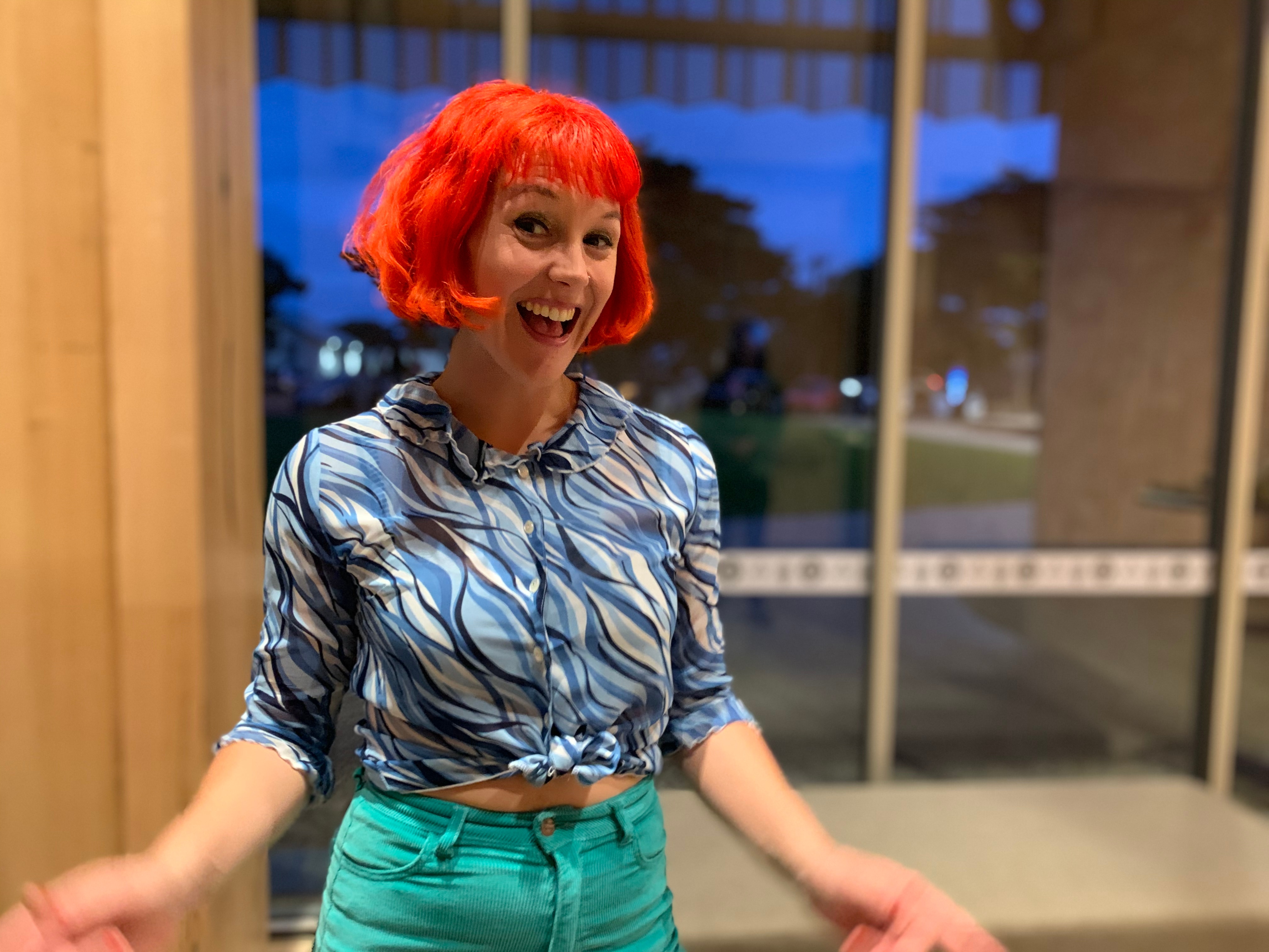 Young women with bright coloured hair smiling at the camera 