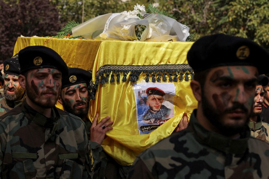 Members of Hezbollah carry the coffin of Hezbollah member  killed in southern Lebanon.