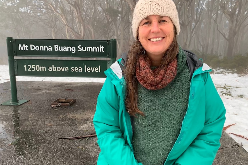 A photo of Nic Fox standing in front of a Mount Donna Buang sign.