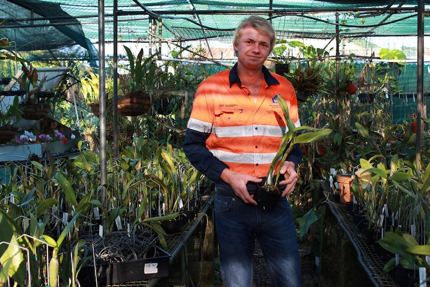 Cale Shoesmith holding one of his orchids.