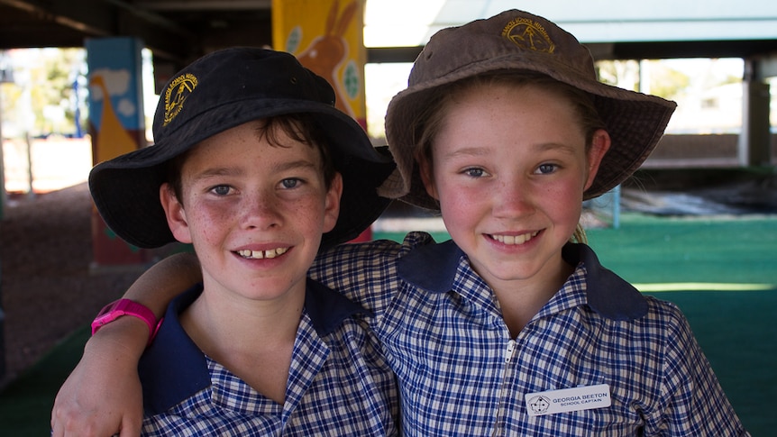 Georgia Beeton, 11, (right) with her brother Sydney, 10, in the playground at St Francis School in Hughenden.