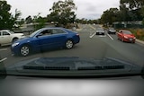 A dash-cam captures a near miss at an intersection in Canberra.