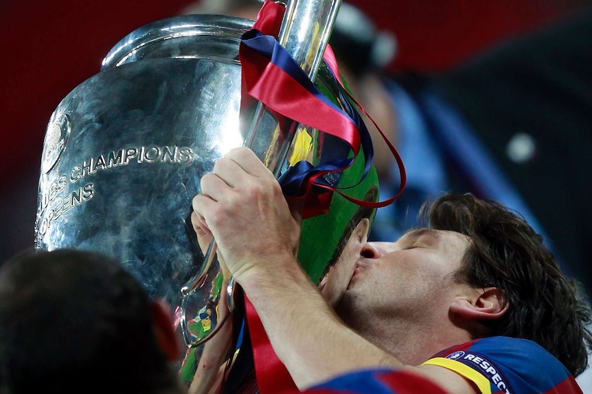 Barcelona's Lionel Messi kisses the trophy after their Champions League final win over Manchester United in London May 28, 2011