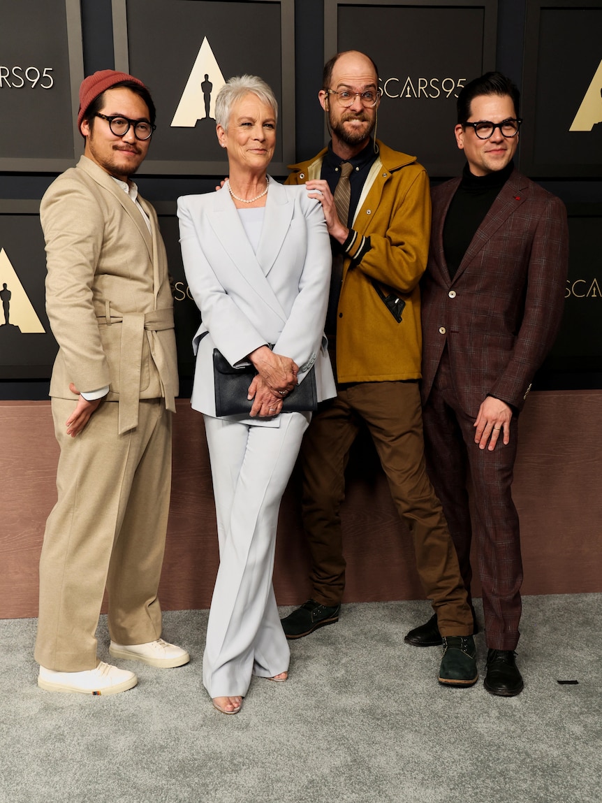 Daniel Kwan, Jamie Lee Curtis, Daniel Scheinert and Jonathan Wang stand together on a red carpet. 