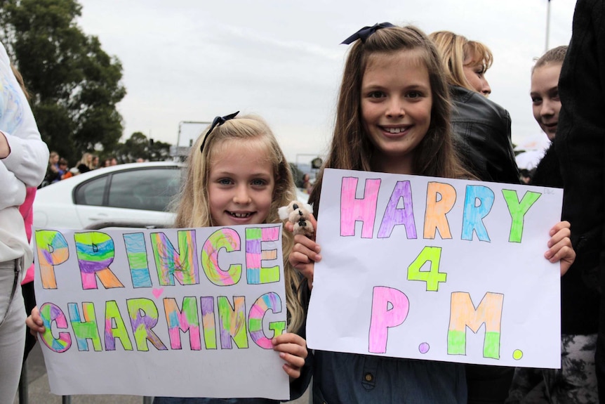 Mia Cooper seven and Ella nine wait for Prince Harry in Canberra April 6 2015