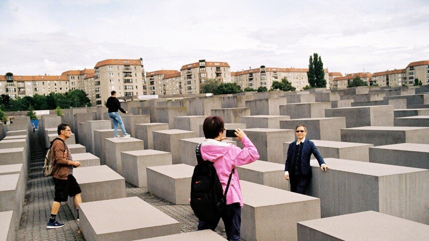 A tourists grab a selfie at the Memorial to the Murdered Jews of Europe.