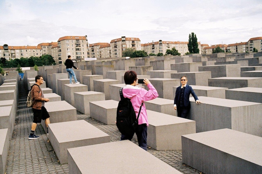 A tourists grab a selfie at the Memorial to the Murdered Jews of Europe.