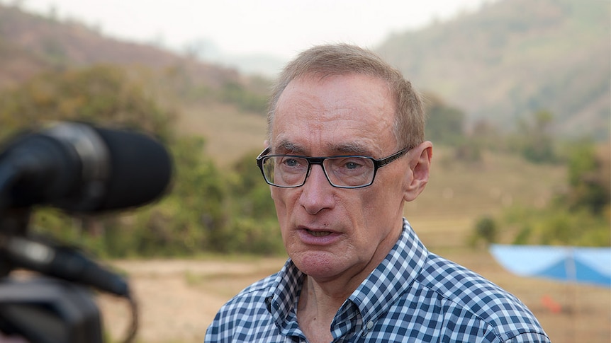 Bob Carr speaks into a camera