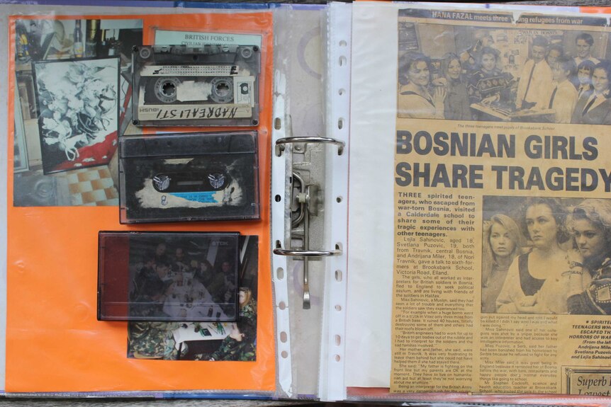 Top shot of cassette tapes and photos in an album.