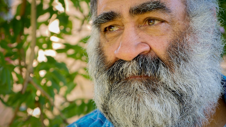 Close up of bearded man looking into the distance.