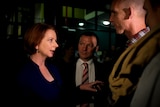 Julia Gillard, flanked by local MP Graham Perrett, meets a member of the public before community cabinet in Brisbane.