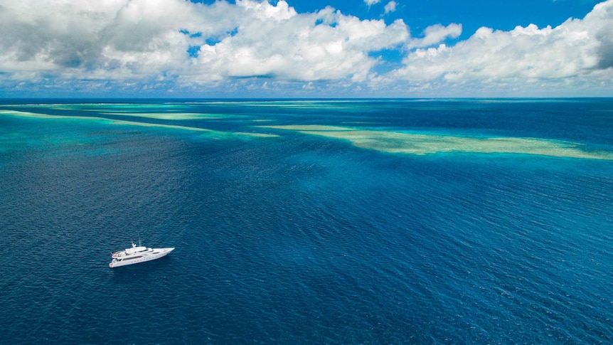 An aerial shot of a research ship in the Great Barrier Reef.
