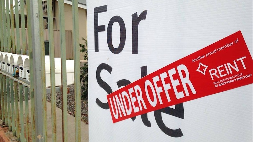 A sign outside a property with an 'under offer' sticker generic