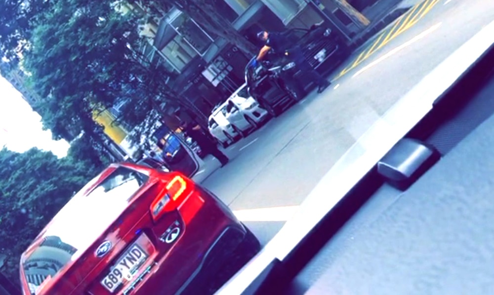 Two police officers pointing their guns at a car