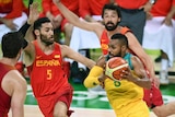 The Boomers' Patty Mills drives past Spain's Sergio Llull at the Olympics