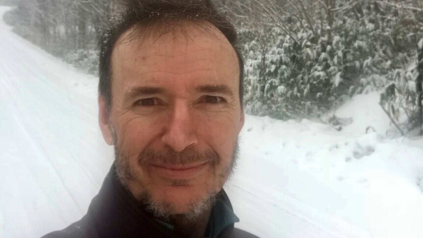 Former Redland councillor Craig Ogilvie stands on a snow-covered road.