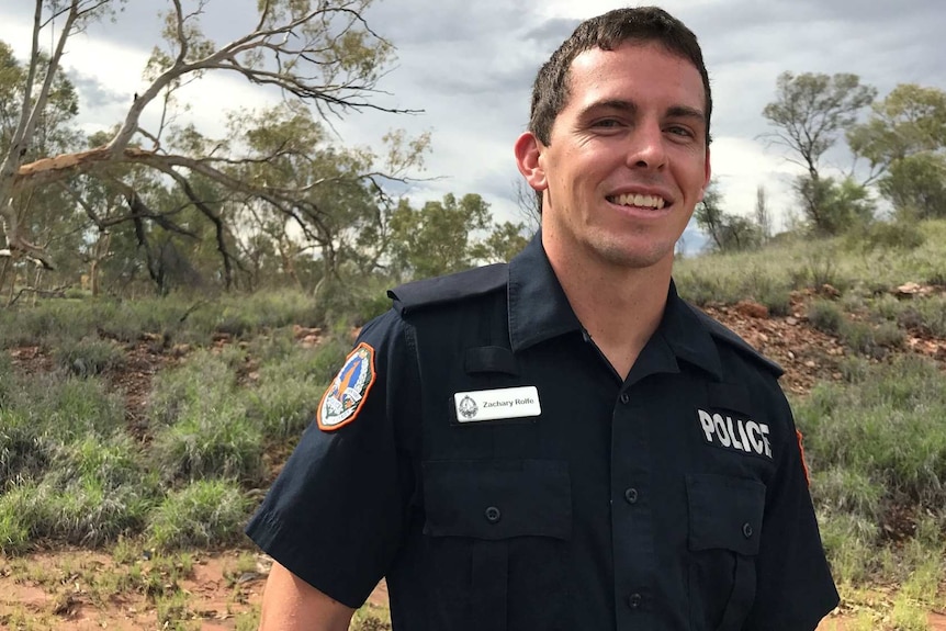 A close up photo of Constable Zachary Rolfe smiling while he stands outside in Alice Springs.